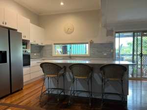 Kitchen Cupboards and Island Gloss White Stone bench tops One Year Old
