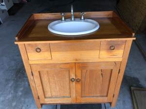Custom made hardwood timber bathroom vanity, includes sink and tap.