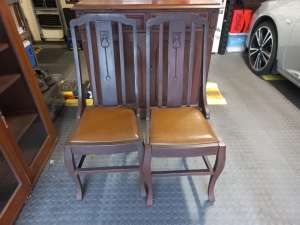 Two Dark Wooden High Back Chairs