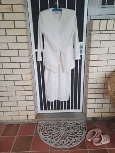 Ladies cream suit, lined, patterned with cream cord. Worn twice.