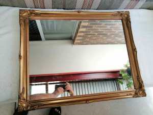 Large wall mirror in a beautiful gilded wooden frame