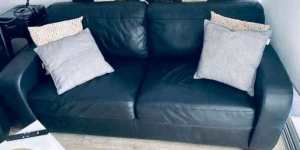 Black leather lounge with pull out sofa bed and recliner cha
