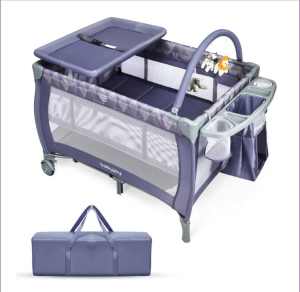 Portable travel cot , with changing mat and mobile