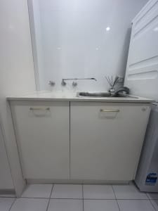 Laundry cabinetry, stone top, sink and tap