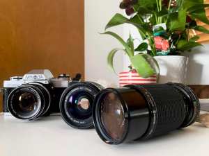 Minolta X-300 vintage 35mm film SLR camera with 3 lenses included.