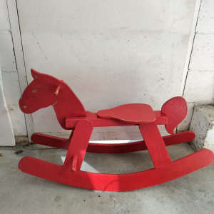 Vintage red painted timber rocking horse. 