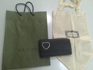 Gucci wallet with heart detail and packaging