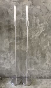 Pair of tall stainless steel silver Events Candelabra with candles