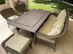 Outdoor table with sofas and stools