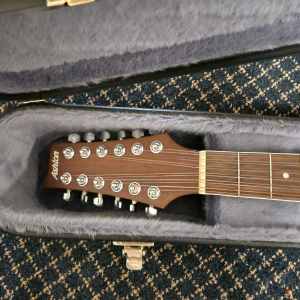 1x12 string Ashton Acoustic guitar with hard carry case.