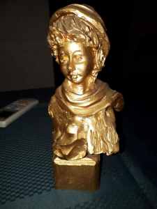 painted gold statue of lady