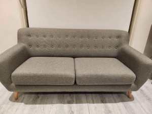 Scandi style grey couch with wooden legs