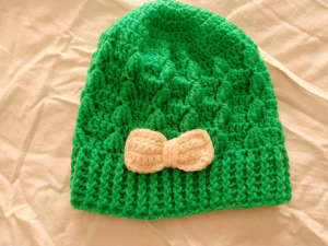 Ladies hand crochet beanie. Has a cream bow.