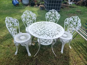 Large cast aluminium table with four chairs