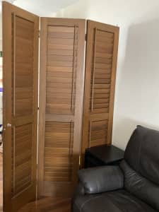 Three panel wooden room divider with opening slats