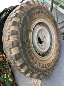 4X4 TYRE ON WHEEL IS NEW. IT LOOKS DIRTY CAUSE IT WAS SLUNG UNDER REAR