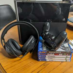 PS4 with controller and games