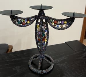 Candle holder decorated with colorful handmade beads