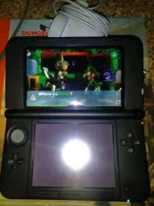 Nintendo 3DS XL console with game 