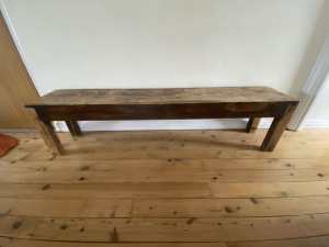 Long solid wooden bench