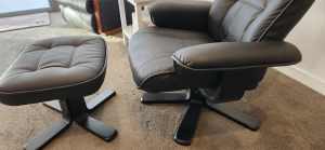 Black recliner / swivel armchair plus matching ottoman