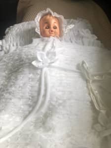 Doll with pillow and blanket.