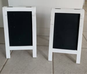 Small white timber framed blackboard signs