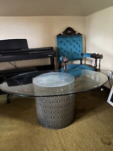 Beveled edge glass coffee table with metal pedestal.