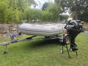 Evinrude E10R64 9.8 HP Motor and rubber inflatable boat on a trailer