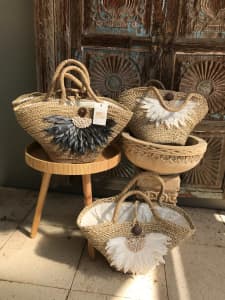 WICKER BASKETS WITH FEATHER AND SHELL DETAIL