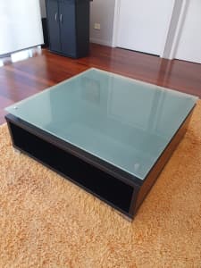 Solid coffee table with storage space, glass top