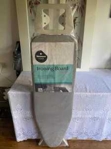 Brand new ironing board with padded cover