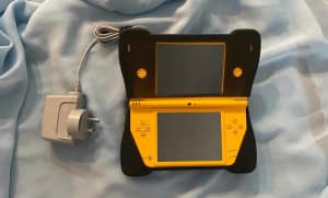 DS Nintendo XL yellow Console with DreamGear Comfort Grips, preowned