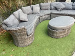 Outdoor grey semi circular couch and table