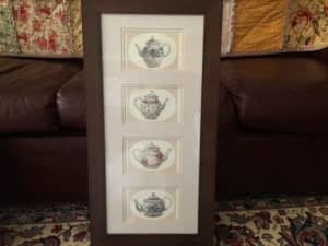 Timber framed picture of four individual decorative tea pots.