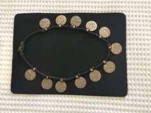 Vintage Indian silver coin necklace on a woven band