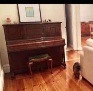 Upright piano and stool.