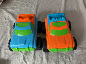 2 plastic toy trucks (20 cm long) 