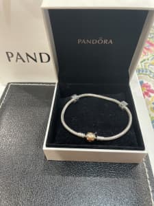 Pandora bracelet with gold clasp and two tone stoppers