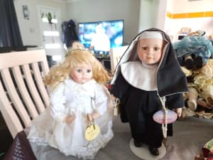 Selection of Porcelain dolls nun and kneeling communion girl.