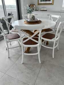 Round table with oak legs and 6 timber chairs with rattan seats