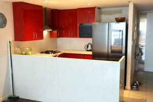 Full kitchen with Caeserstone benches, cabinetry and appliances