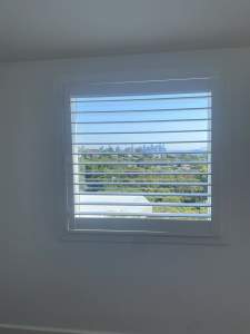 White aluminium framed windows and/or white plantation shutters