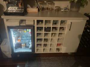 Bar cabinet wine rack. Mini fridge space.
