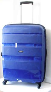 LARGE SIZED HARD CASE SUITCASE WITH FOUR WHEELS BY AMERICAN TOURISTER