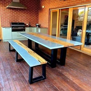 Live edge hardwood timber and concrete indoor/outddoor dining table.