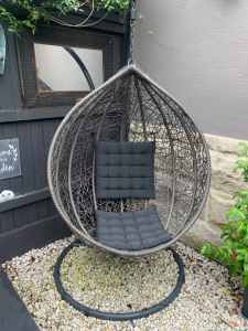 Large egg chair in grey rattan with stand and black cushions