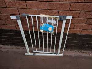 Baby gate with attachments, spans a doorway 
