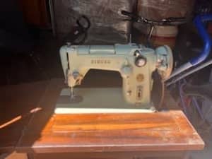 Vintage Singer belt driven sewing machine plus cabinet.
