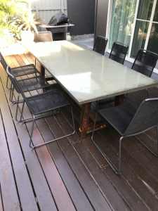Natural concrete dining table with Walnut color legs 